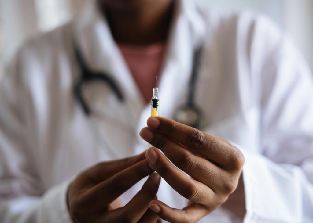 Doctor holding a vaccine needle